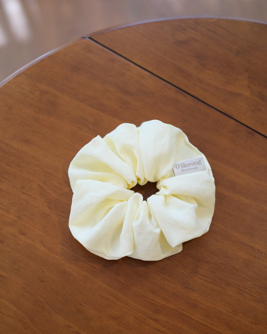 Butter yellow scrunchie on wooden table